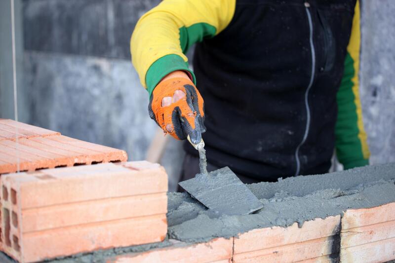 a man installing concrete blocks